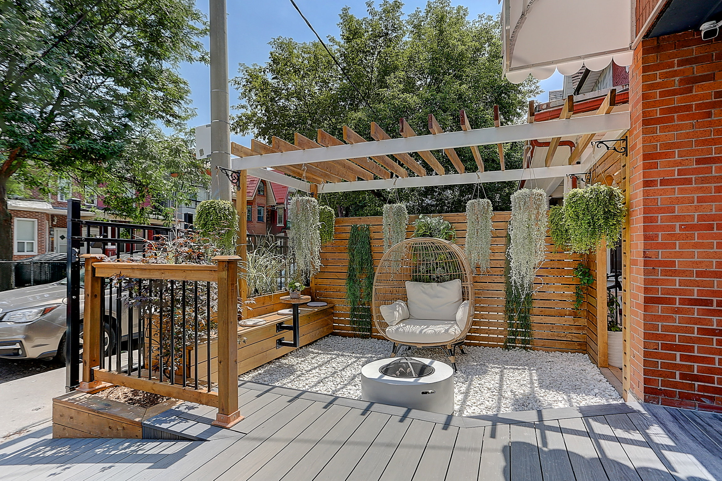 Outdoor living space with pergola, seating area, fire feature, and modern landscaping